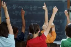kids raising hands in school_0