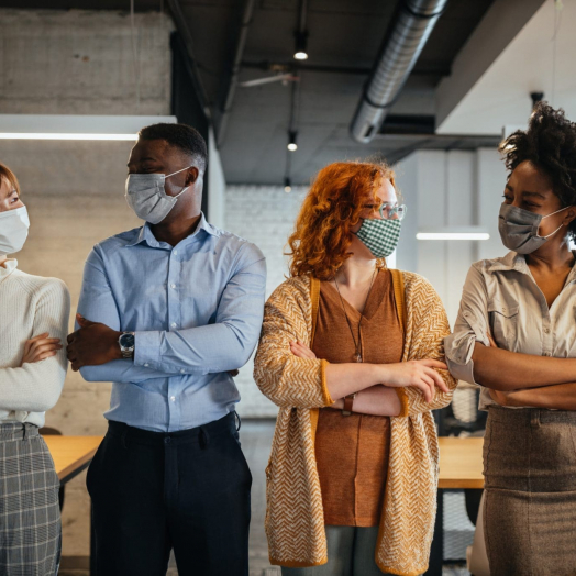 Business people wearing a face masks to avoid COVID-19 Team of colleagues with masks for protection from corona virus standing in the office